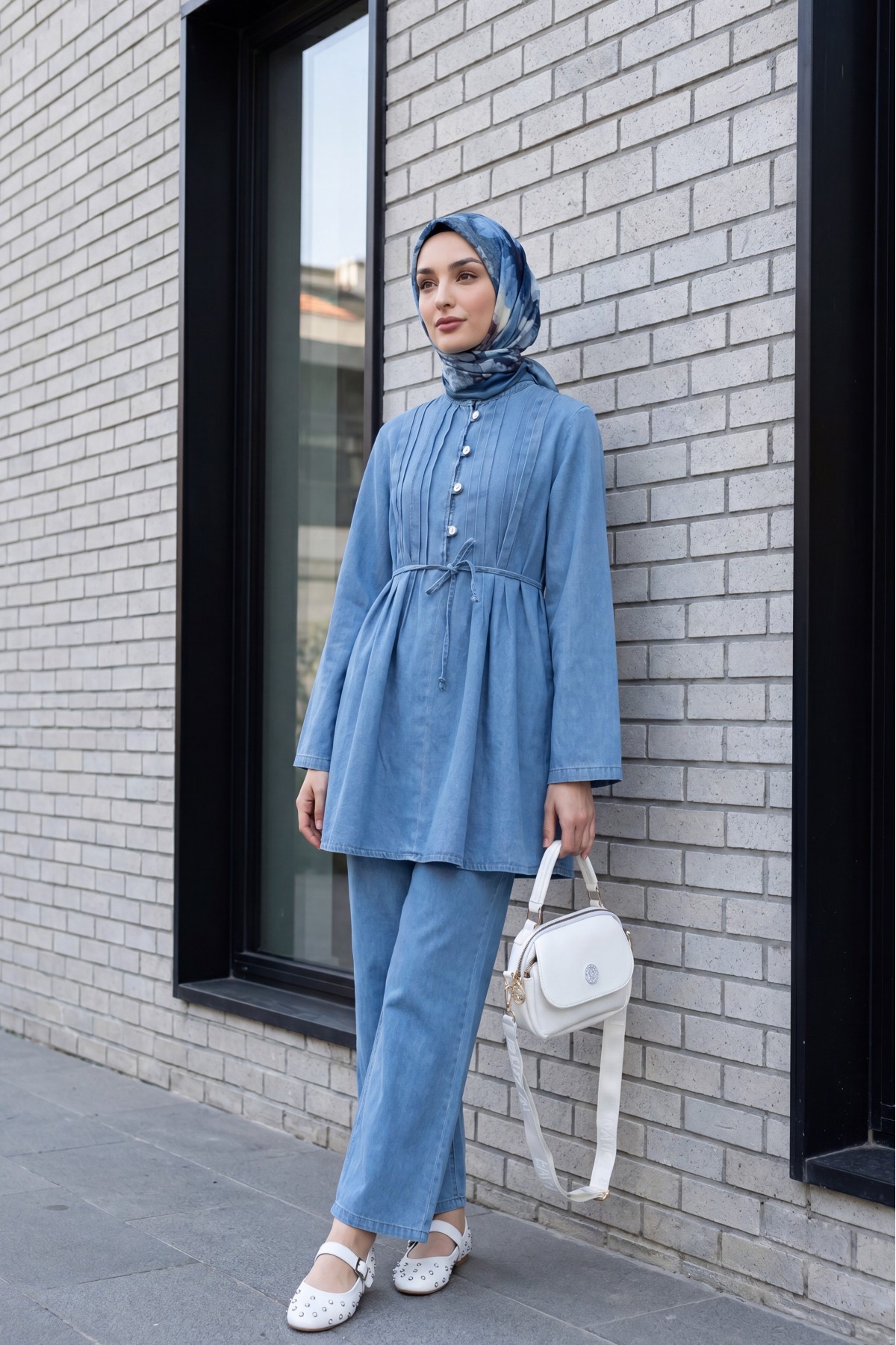 Half-buttoned, pleated front, tie-waist denim suit with trousers. -Light blue